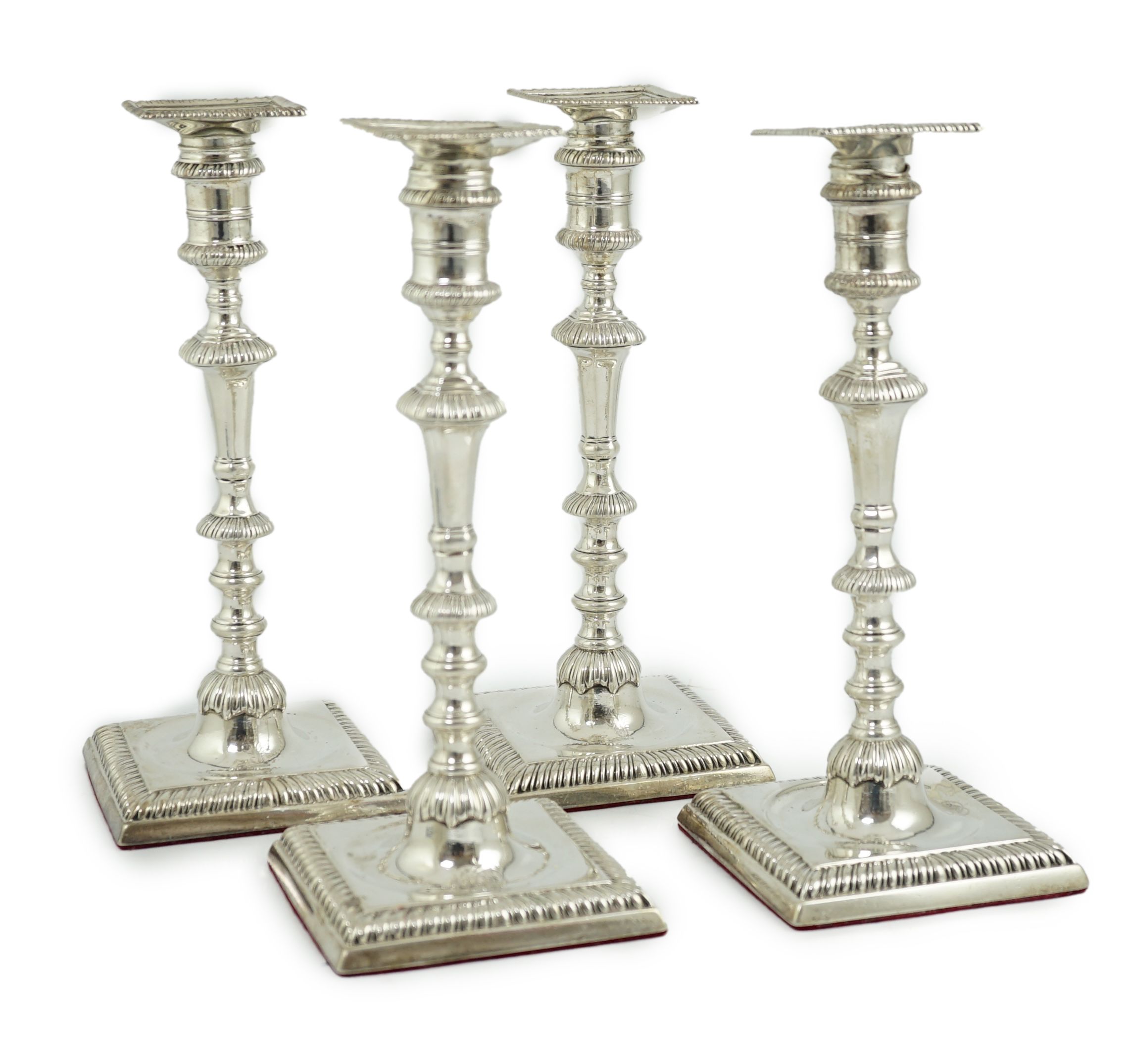 A matched set of four George III silver candlesticks
